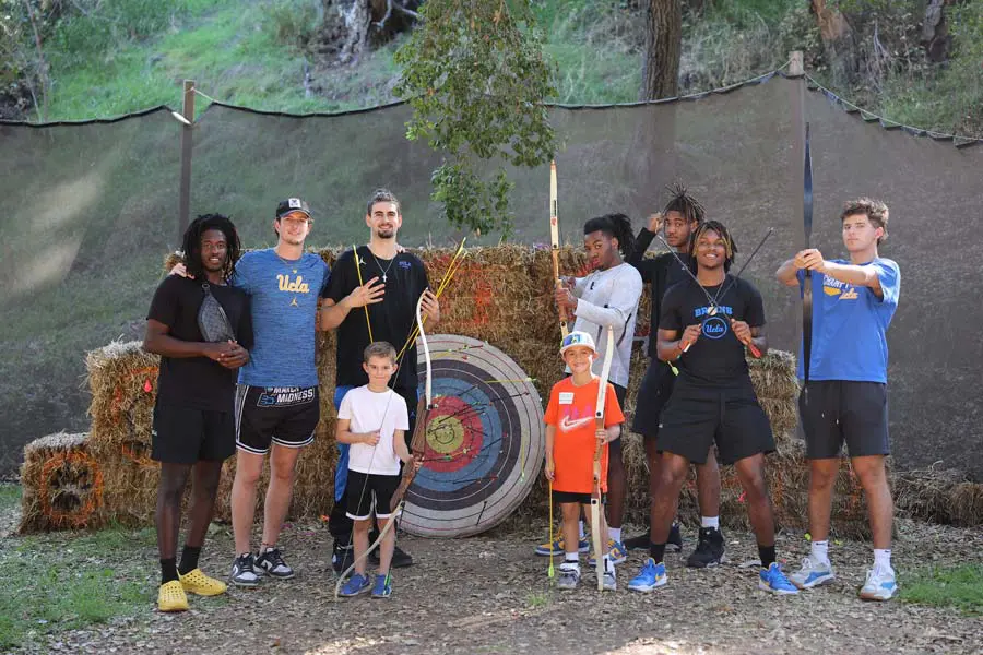 Student-athletes posing with participants