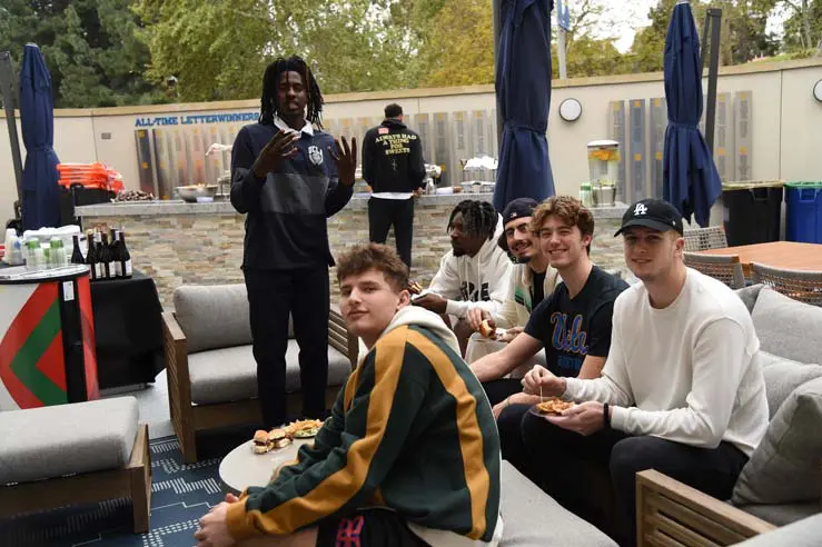 Student-athletes posing with fans